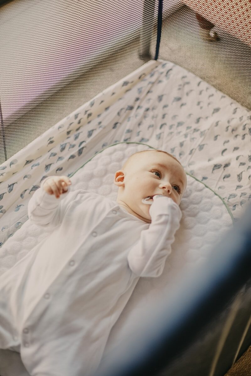 Baby in a travel crib